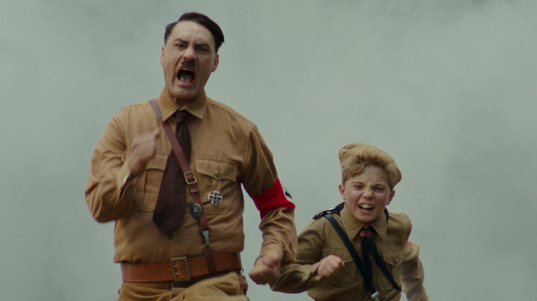 Hitler running happily with a young boy 