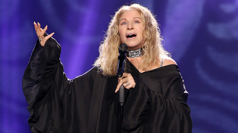 Barbra Streisand gesturing while singing onstage