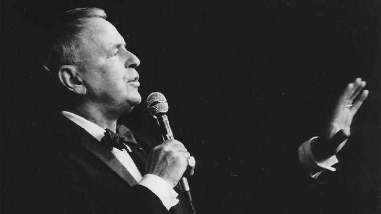 Frank Sinatra gesturing while singing onstage