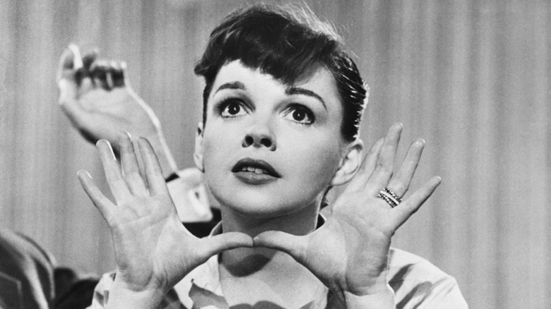Judy Garland framing her face with her hands