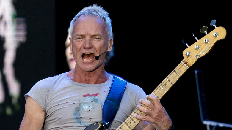 Sting singing and playing bass guitar
