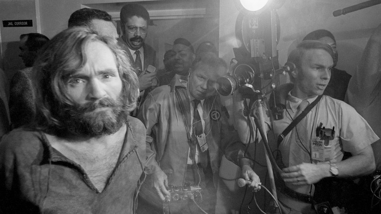 Charles Manson being led into court as cameramen film