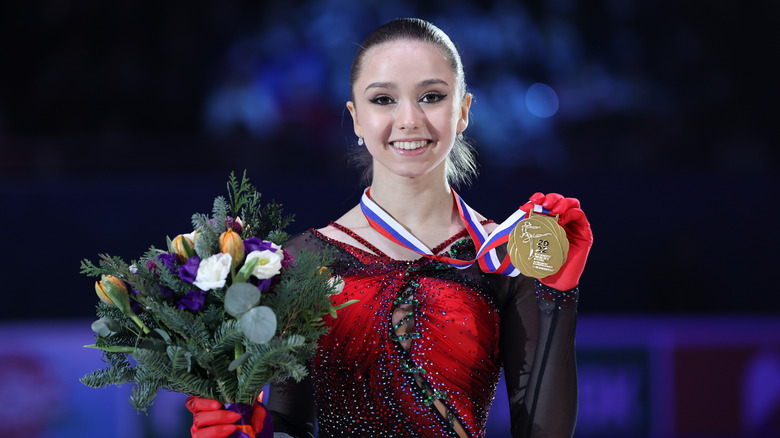 Kamila Valieva with a medal and flowers