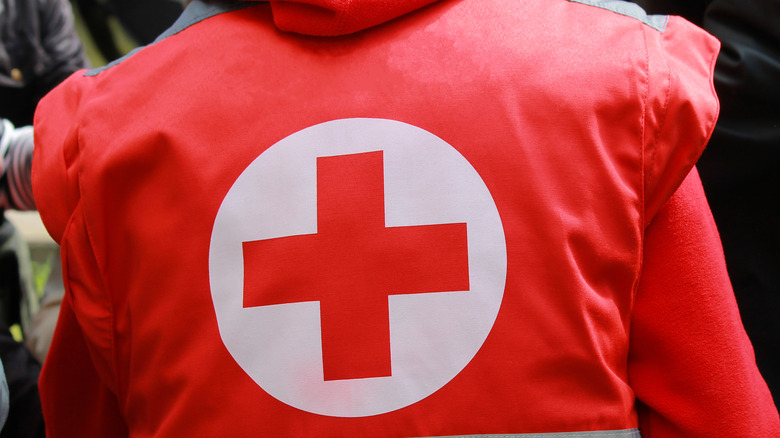 Red Cross worker with insignia on jacket
