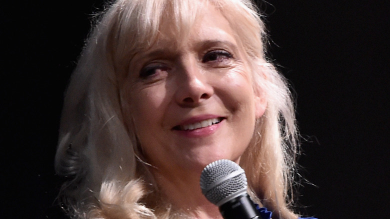 glenne headley smiling with microphone