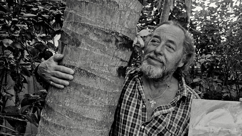 Tennessee Williams hugging a tree