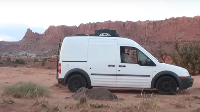White Ford Transit van parked in the desert