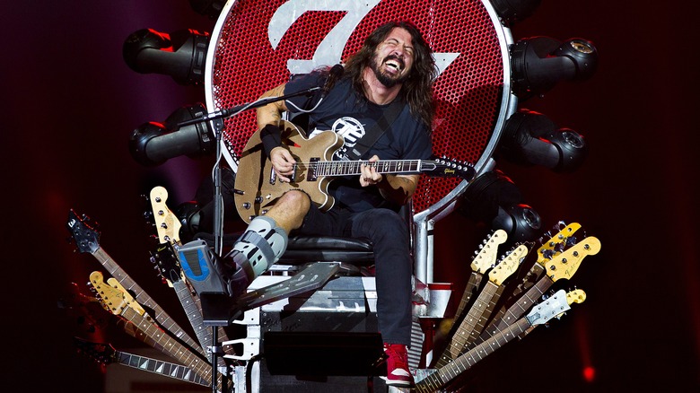 Dave Grohl on stage with his broken leg