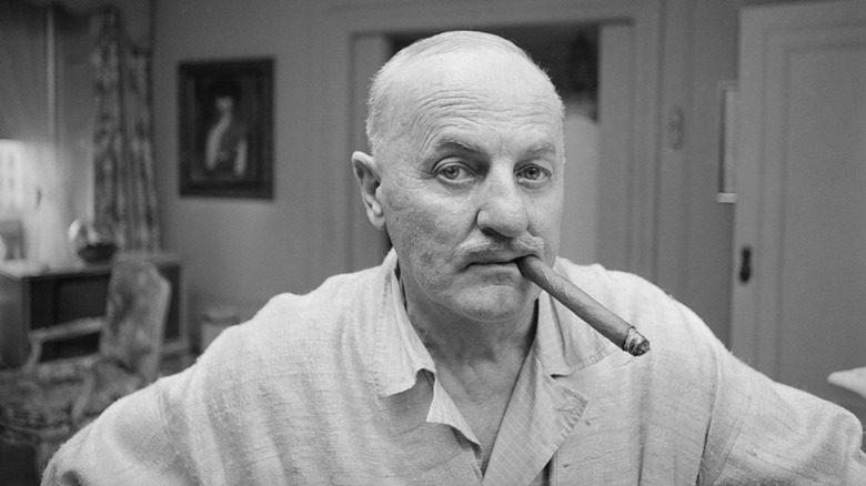 Darryl F. Zanuck smokes cigar