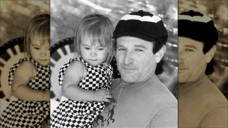Robin Williams hat holding his daughter 