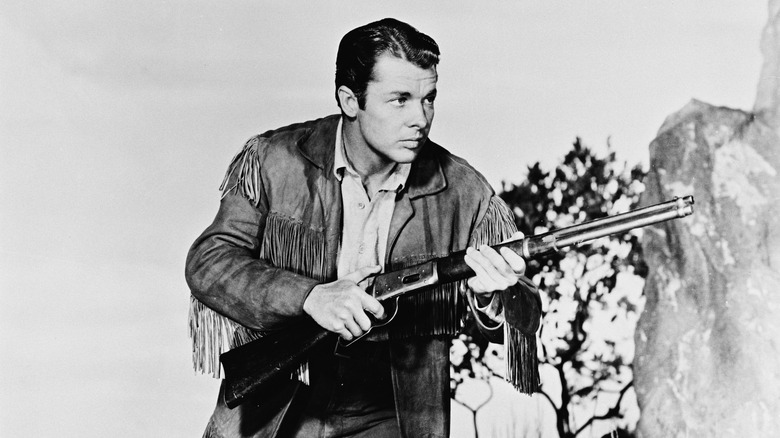 Audie Murphy buckskin jacket holding rifle