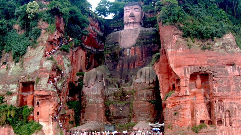 The giant Buddha statue sculpted from cliffs of red stone.