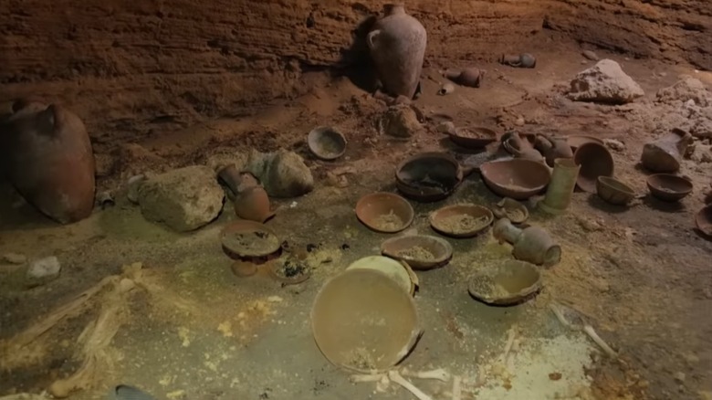 reddish amphorae, bowls in cave