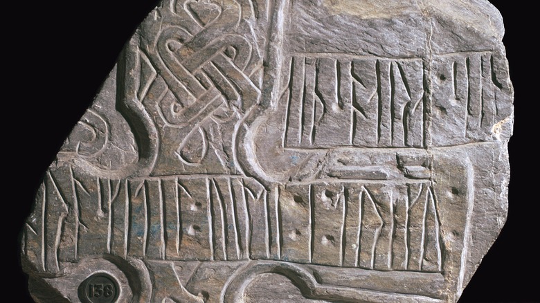 carved rune stone black background