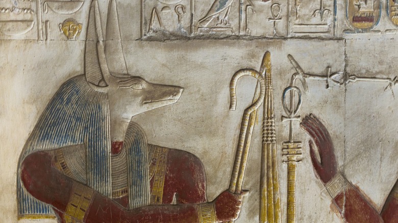 A faded Ancient Egyptian depiction of Anubis