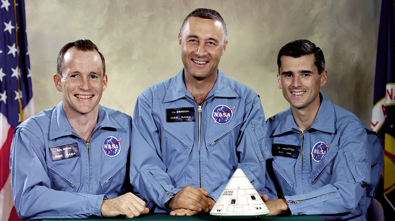 The three Apollo 1 astronauts with a model of the capsule