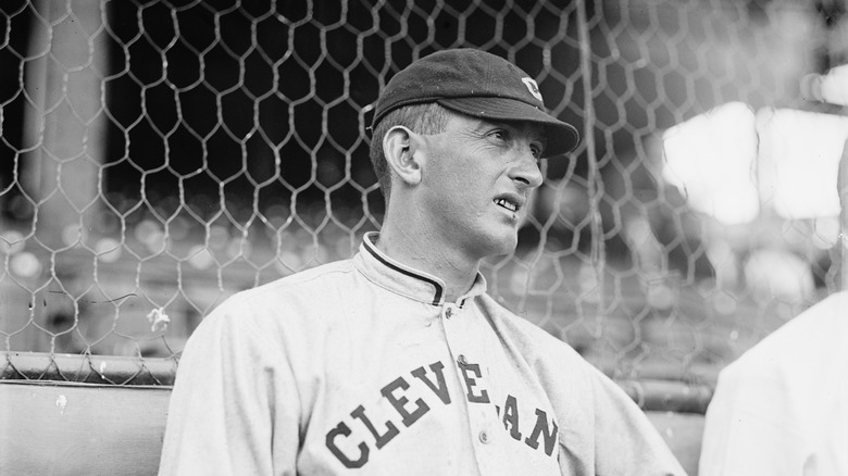 Shoeless Joe Jackson in front of a chain link fence