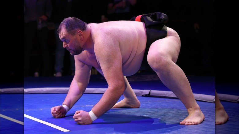 Soslan Gagloev crouching in a sumo ring