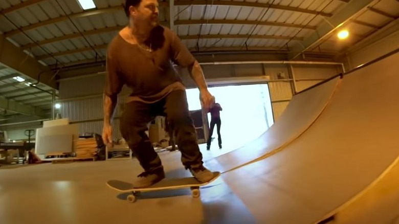 Bam Margera skateboarding half pipe