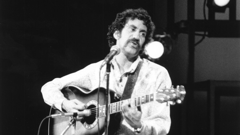 Jim Croce singing and playing guitar on stage