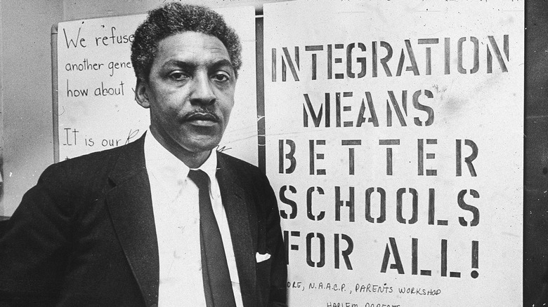 Bayard Rustin in front of sign