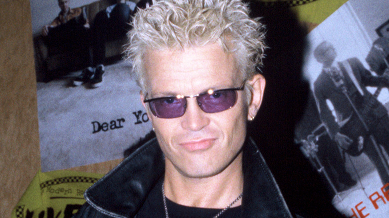 Billy Idol smiling leather jacket purple sunglasses