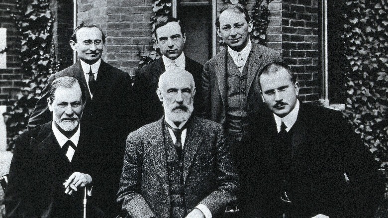 Sigmund Freud and Carl Jung sitting for a photo with other men