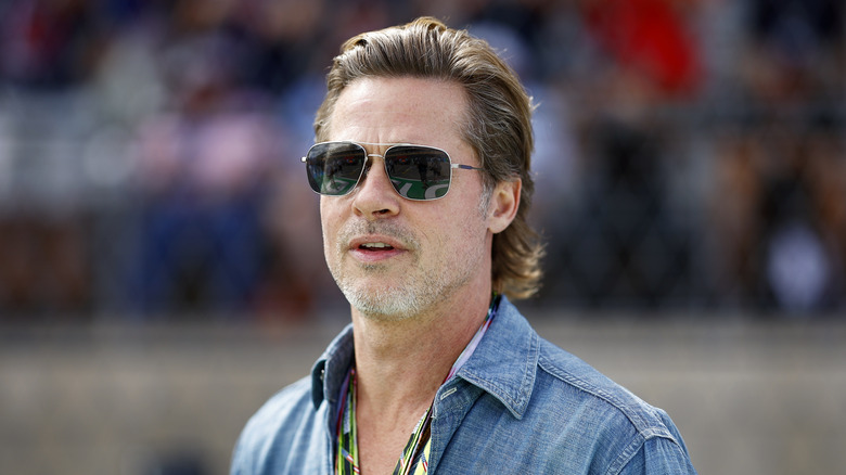 Brad Pitt looks on from the grid at race track