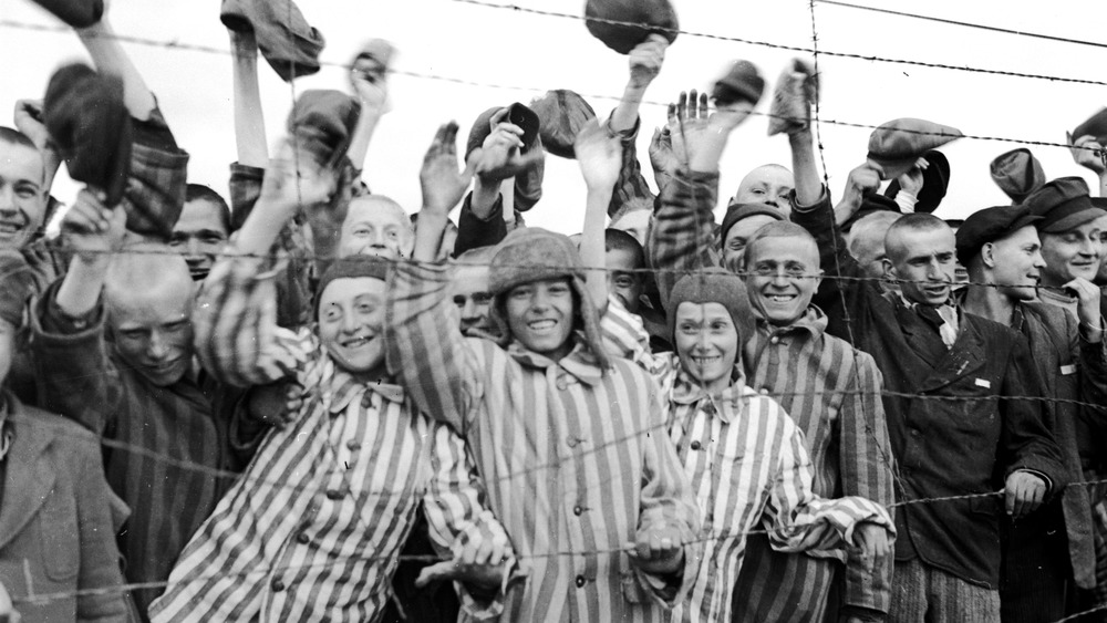 oung prisoners interned at Dachau concentration camp cheering their liberators, the 42nd Division of the US Army. The boy second from left has been identified as 18 year old Juda Kukiela. (Photo by Abrahams/Getty Images)