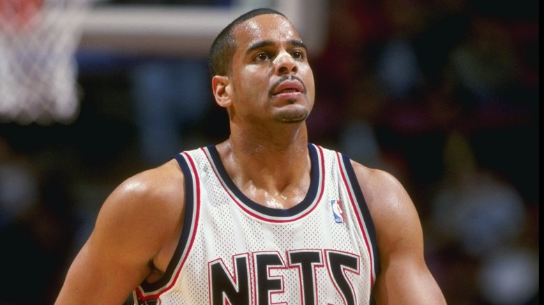 Jayson Williams on the basketball court wearing a Nets jersey