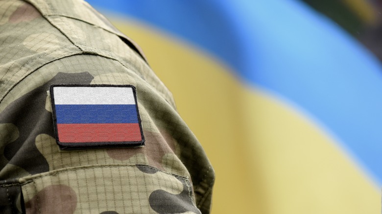 Russian soldier shoulder Ukraine flag