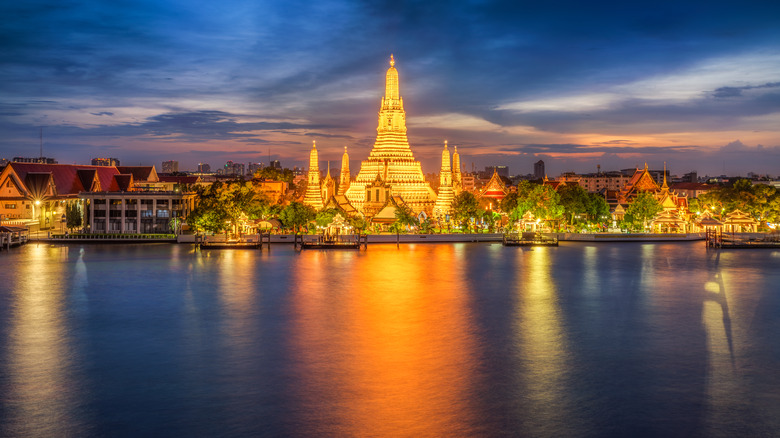 Bangkok with Wat Arun Temple in center at dusk