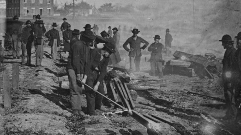 Union soldiers pulling up tracks