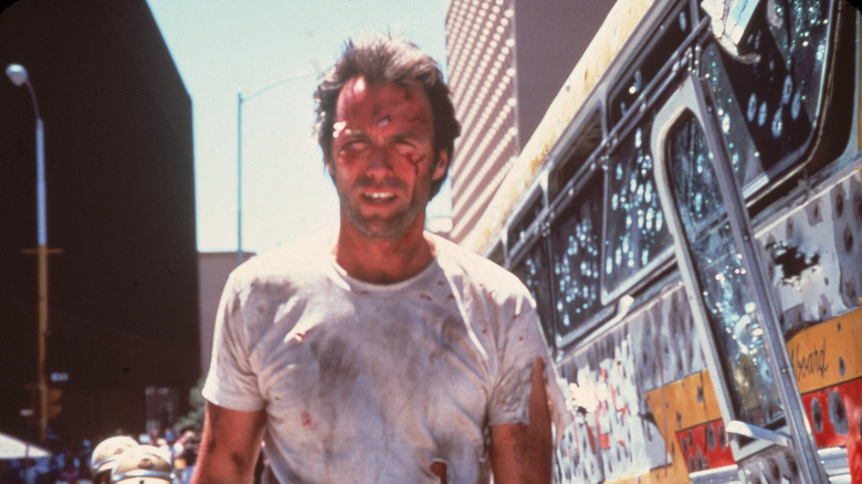 Clint Eastwood covered in mud and blood bus with bullet holes