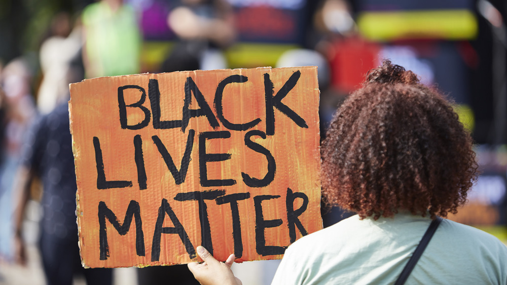 Person with Black Lives Matter sign