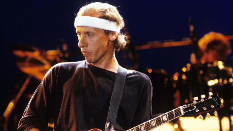 Mark Knopfler performing on stage 