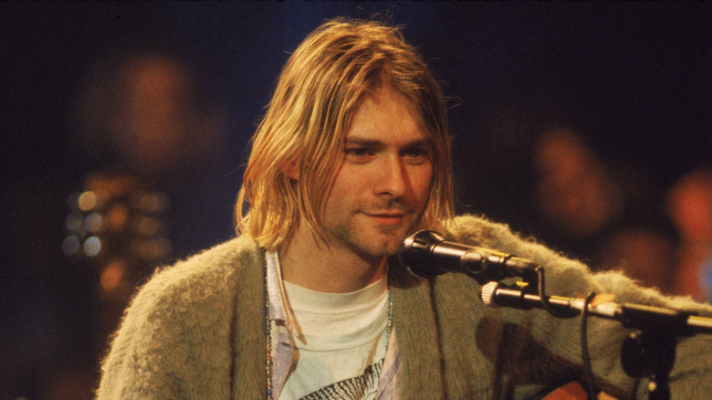 Kurt Cobain performing on stage 