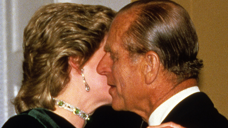 Princess Diana kissing Prince Philip on the cheek