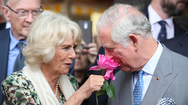 Camilla giving Charles rose