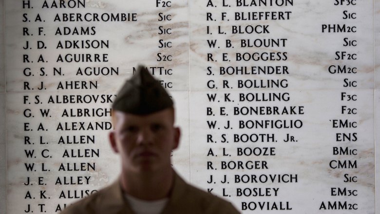 soldier in front of war memorial