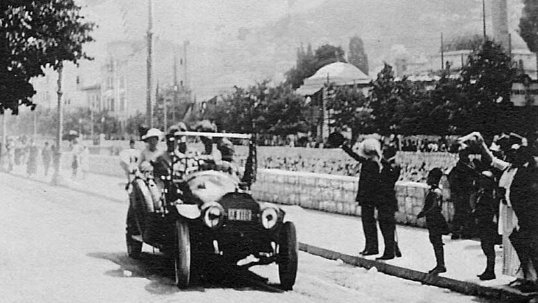 old car WWI driving streets people