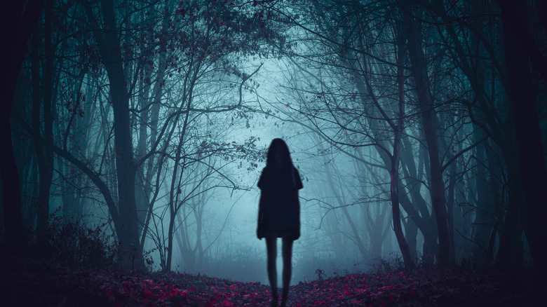 woman in a spooky forest