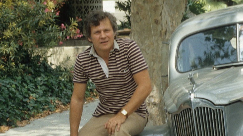 Ken Kercheval leans on his car