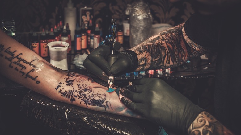 tattoo artist working on a tattoo