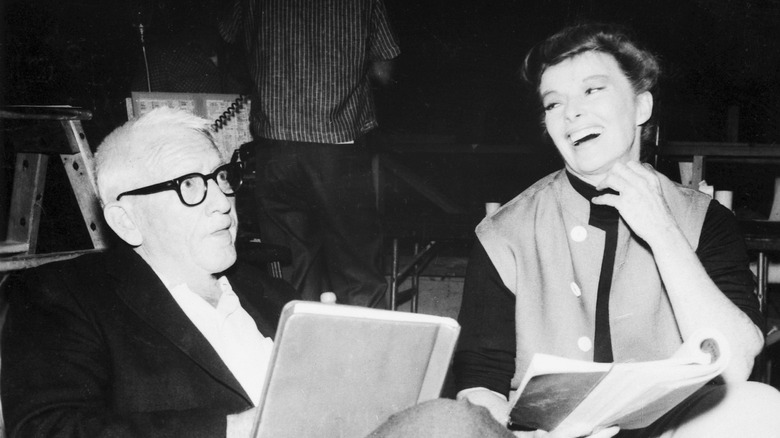 Spencer Tracy and Katharine Hepburn laughing in chairs