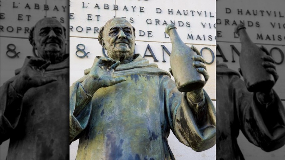Dom Perignon holding champagne bottle