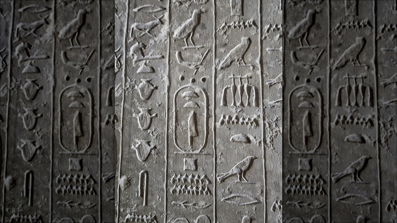 Vertical hieroglyphics on grey stone