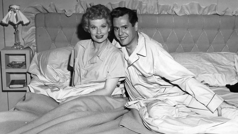 Lucy and Ricky Ricardo smiling on bed