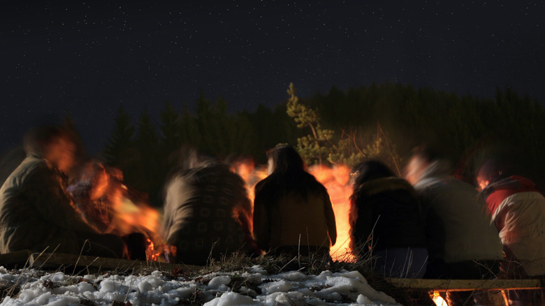 boys sitting around a campfire