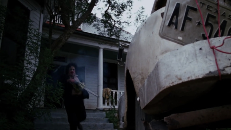 Leatherface running out of house in The Texas Chain Saw Massacre